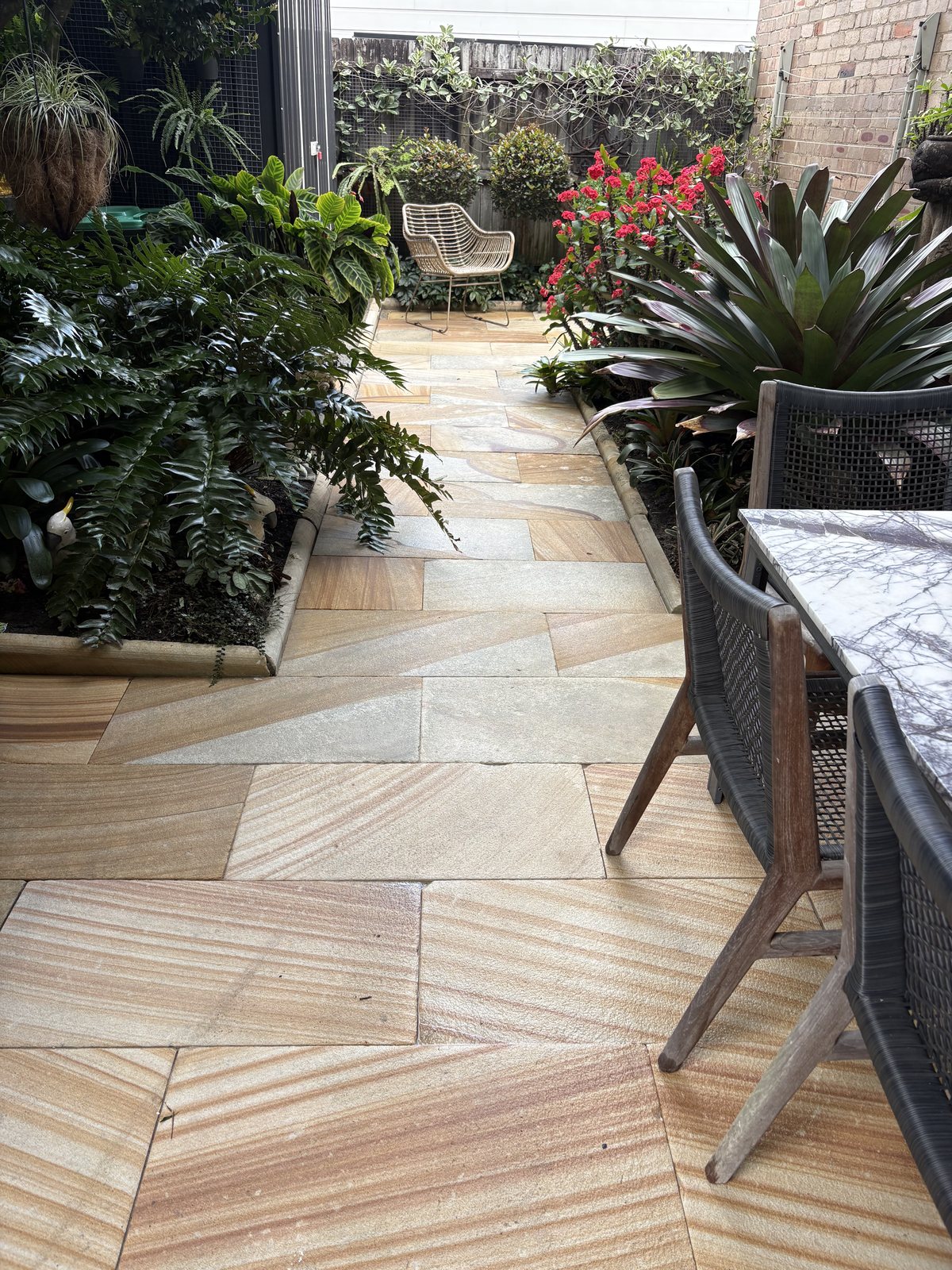 Sandstone garden path in Balmain after cleaning, showing the stone's natural colour and banding