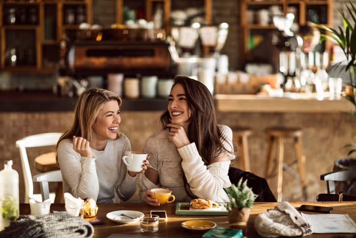 Junges Paar genießt ein Date im Café und lacht.