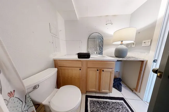 Before: a Queen Anne condo bathroom vanity built around an inaccessible water heater