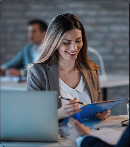 Smiling professional woman working on documents in modern office