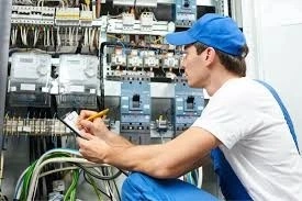 Man testing commercial electrical panel wires.