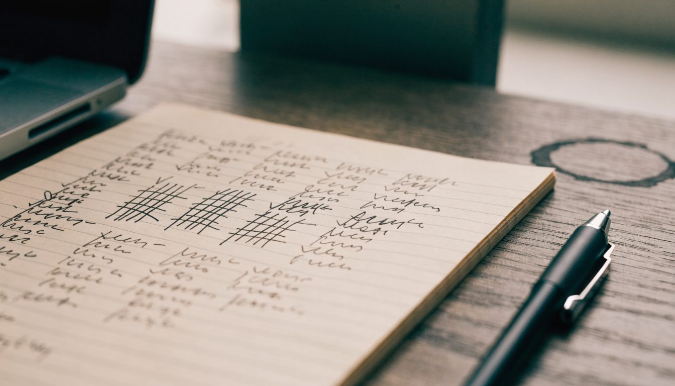 Notepad of handwritten notes tracking themes across contractor reviews