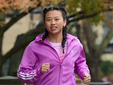 Keira running outside in a pink jacket.