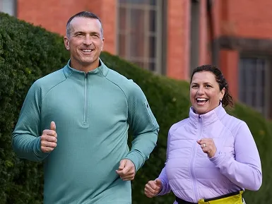 Chris Herren running outside with his wife Heather.