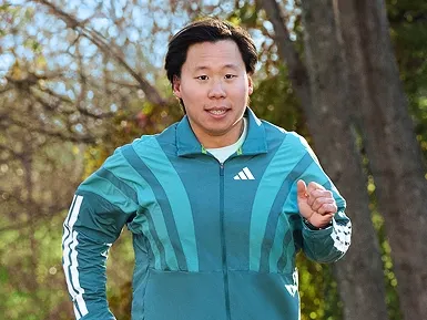 Will running outside in a green Adidas top.
