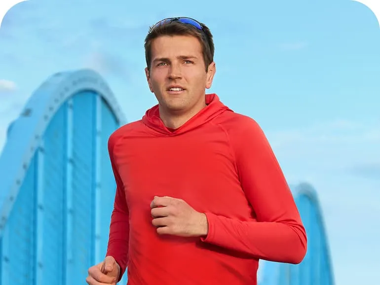 Jack running outside in a red long sleeved top.