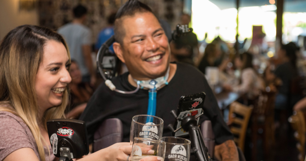 personne handicapée entourée de ses amis au restaurant
