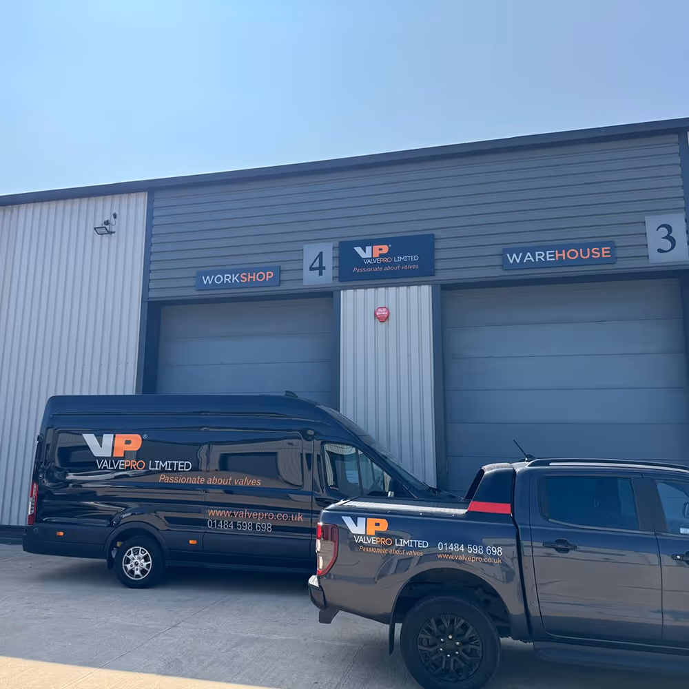 A photo of the rear of the ValvePro headquarters showing a ValvePro van and a ValvePro truck.