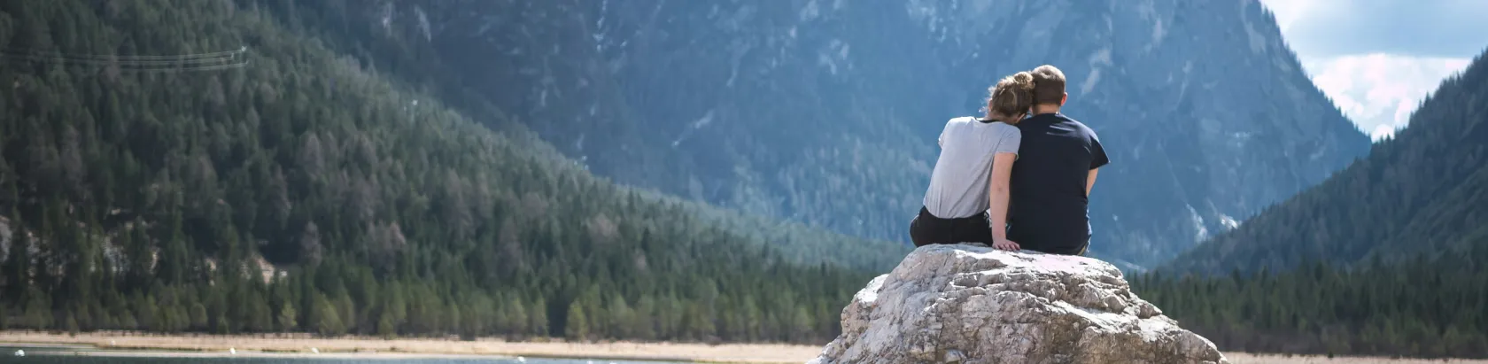 Mother spending time with her family outdoors. She smiles while embracing her children, creating a warm and joyful atmosphere