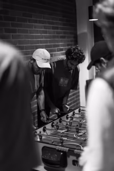 Corti colleagues playing foosball