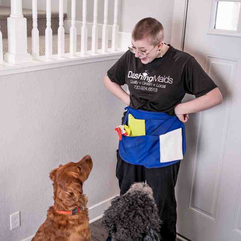 professional cleaner in uniform with eco-friendly products - best commercial/office cleaning in arvada co