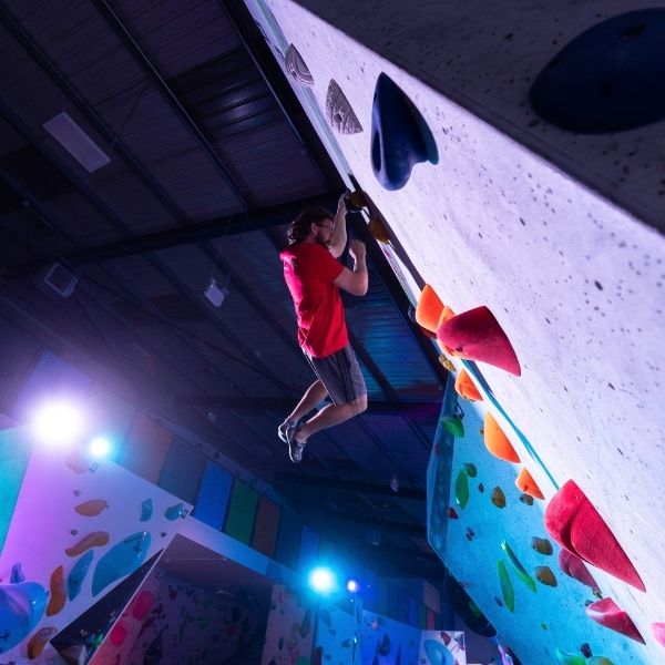 A women climbing in the finals of Subzero 2025 at Substation Macclesfield.