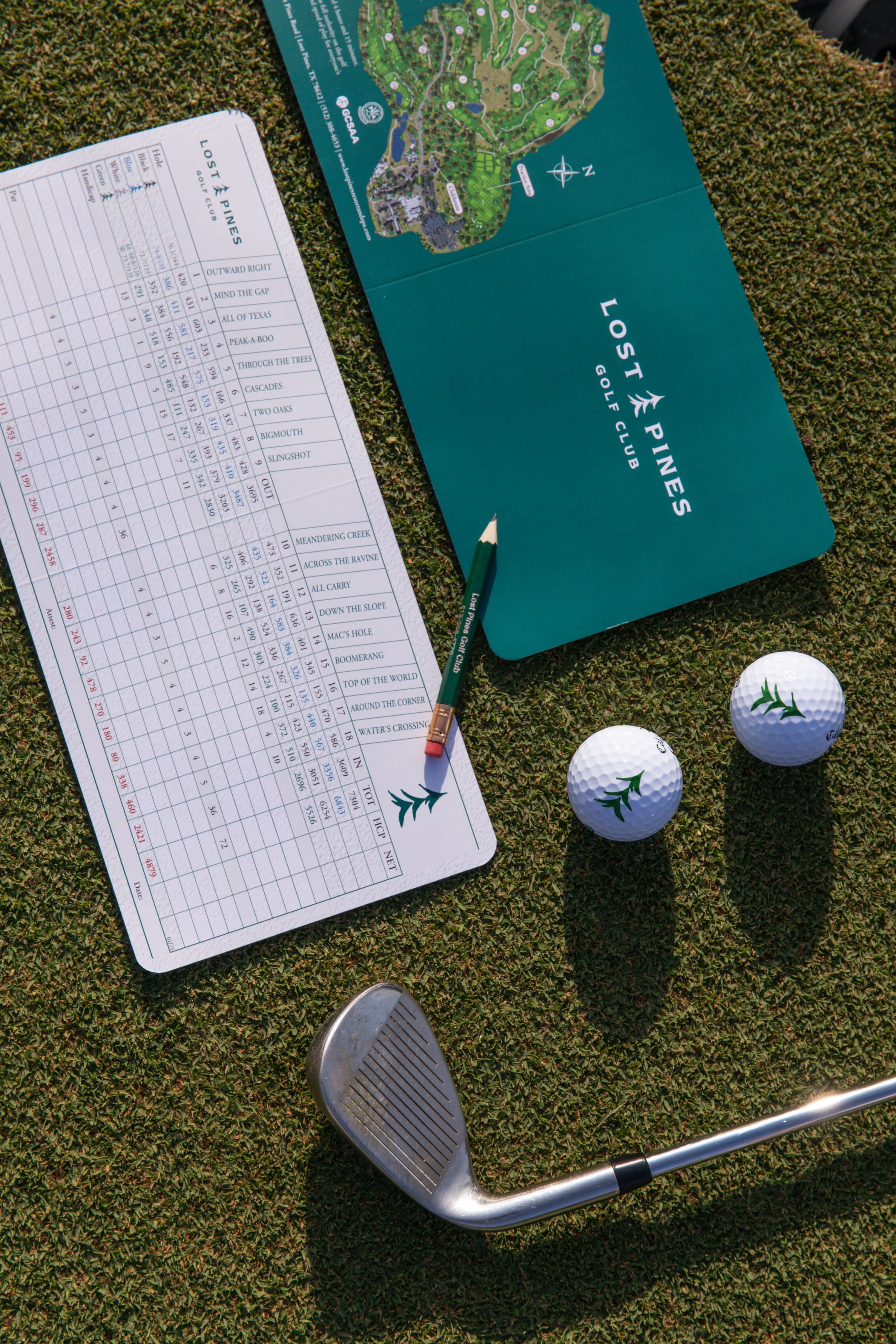 Lost Pines Golf Club golf card, golf balls, and club on the course