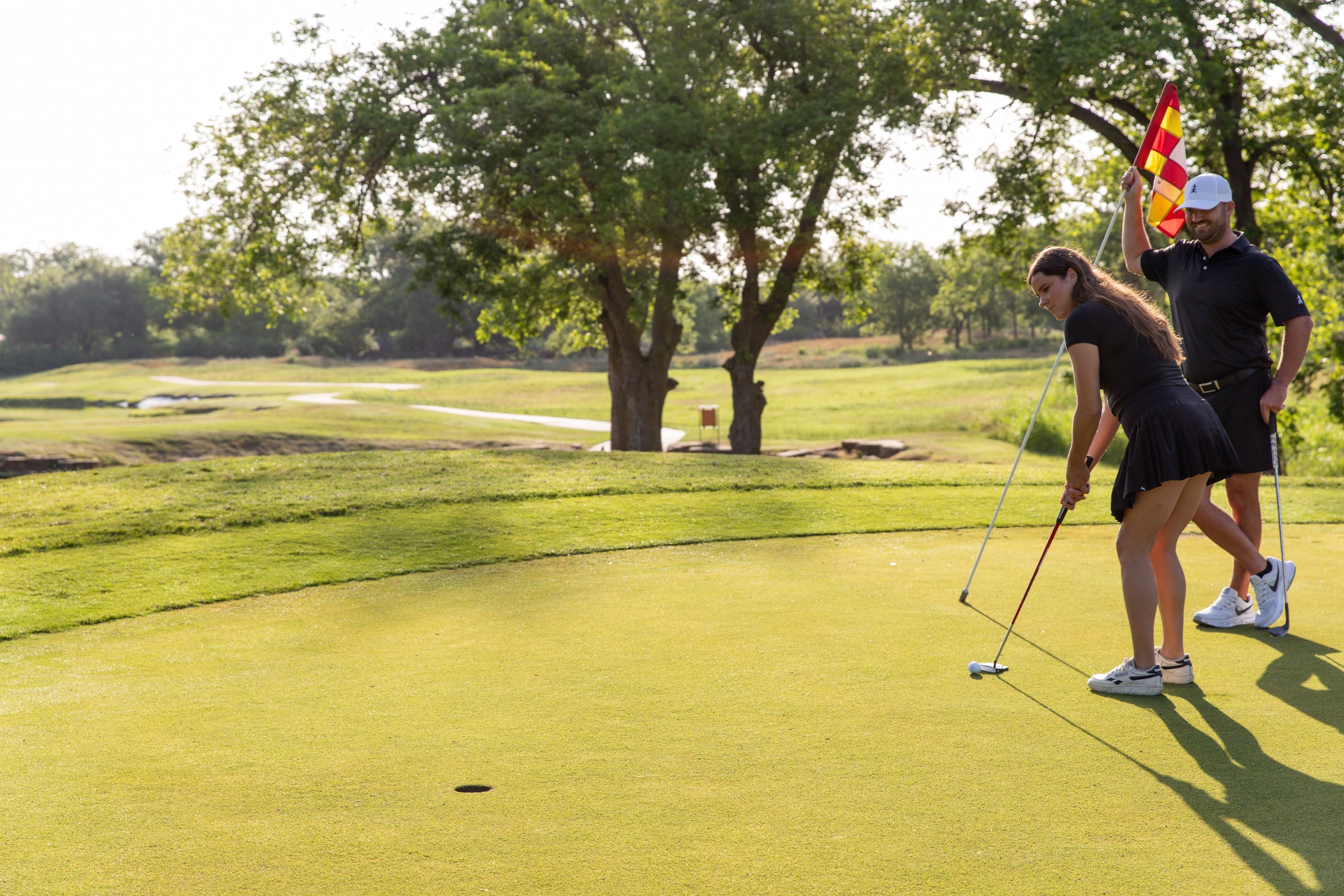 Woman putting with golf instructor at Lost Pines Golf Club