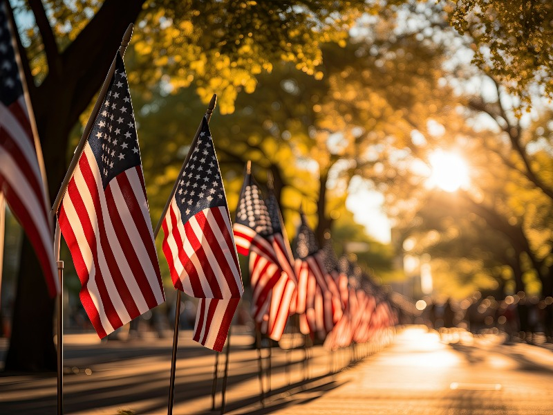 four men golfing and watching on putting green