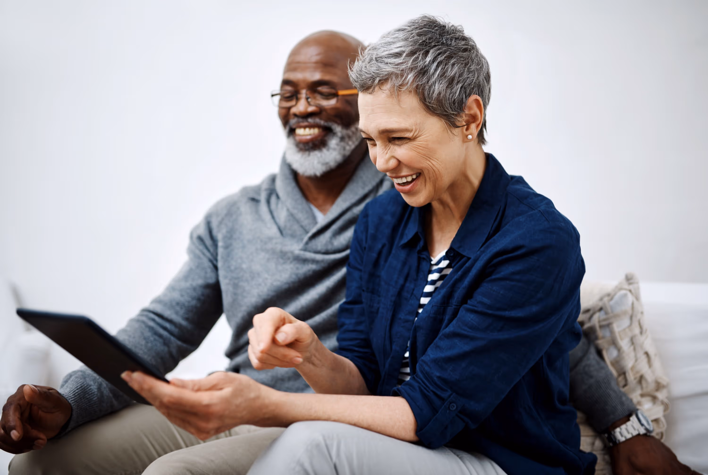 seniors sitting on couch stock image