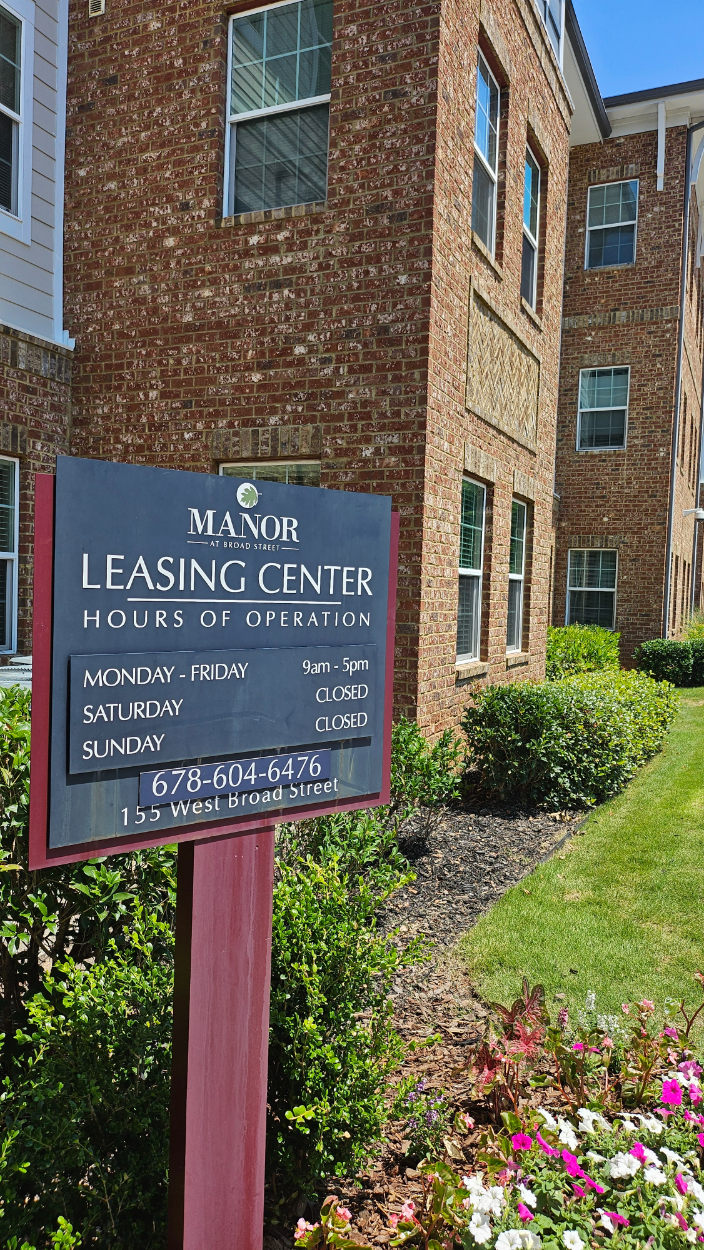 Exterior leasing office hour sign
