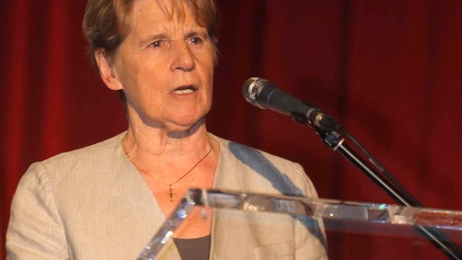Sister Stan speaking at a podium
