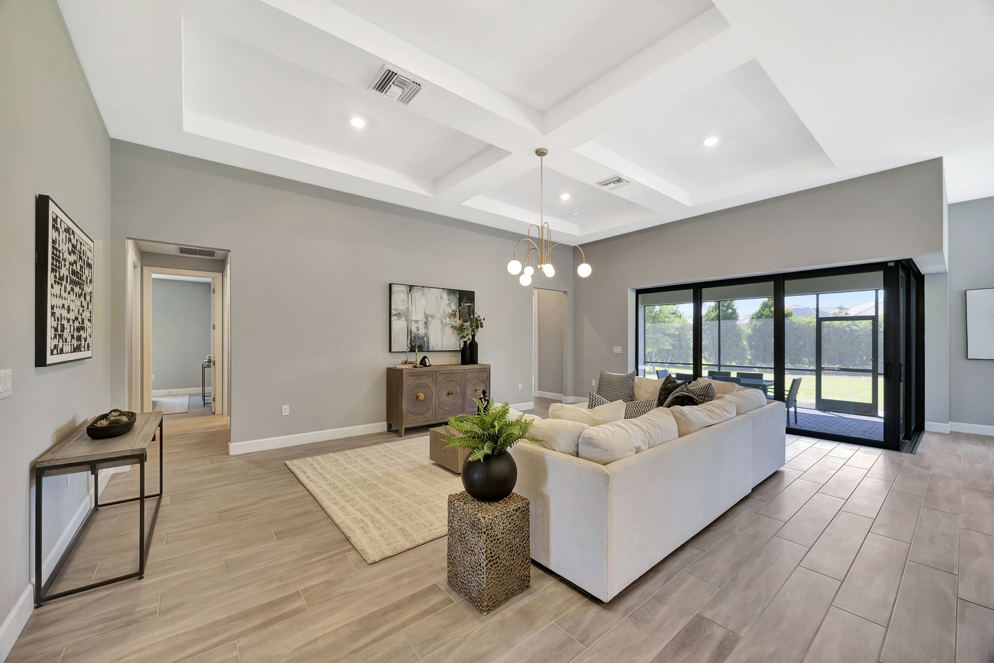 Modern spacious living room with sofa, coffee table, and minimalist decor for stylish short-term rental staging.