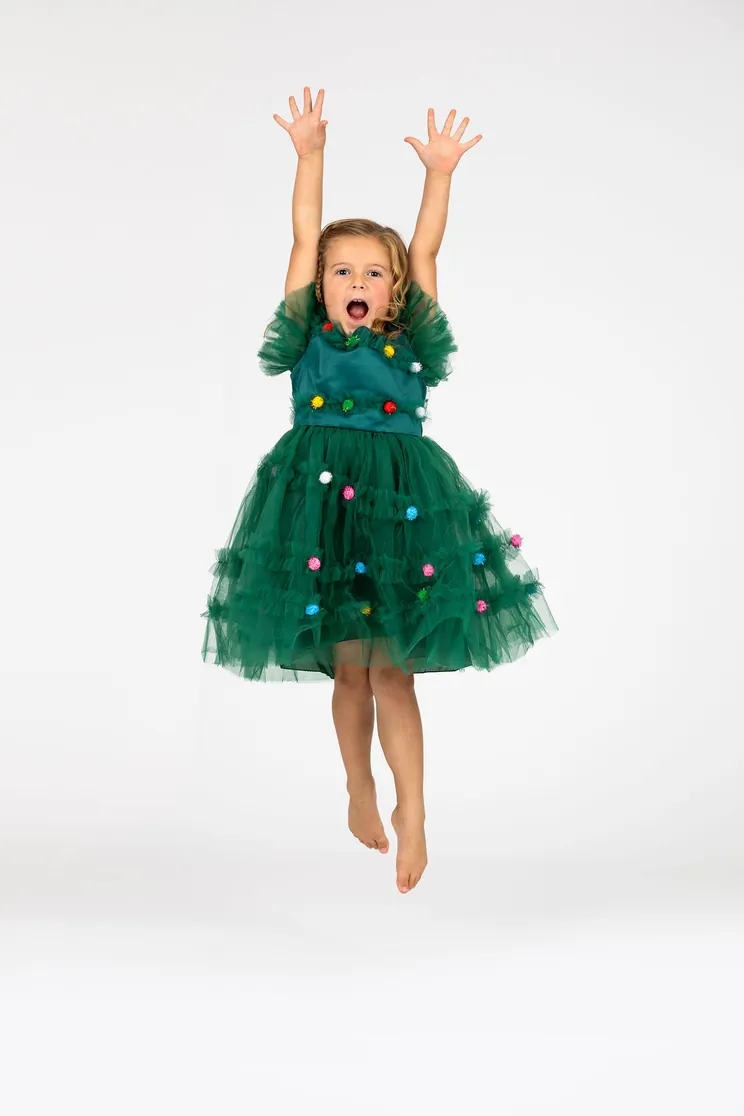 Little Danceology dancer in a green tutu dress jumping with arms up