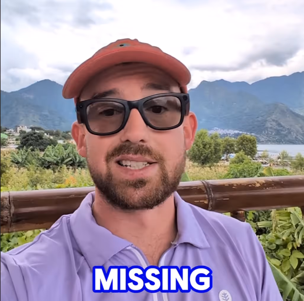 Man wearing sunglasses, a red cap, and a purple shirt standing outdoors with mountains and greenery in the background, with the word 'MISSING' in bold white and blue text at the bottom.
