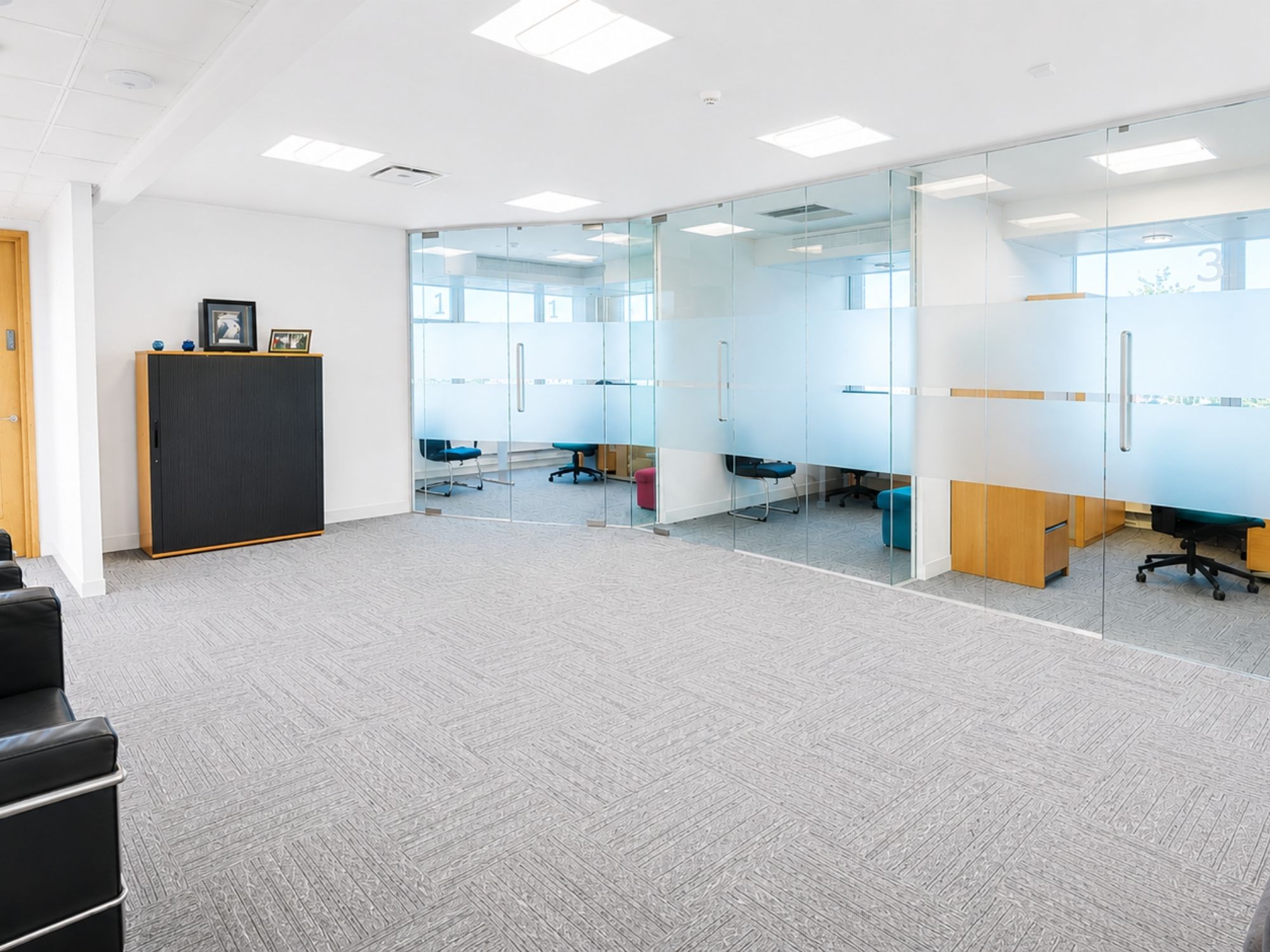Flexible office suite at Cobalt Square with glass-partitioned private rooms and open workspace