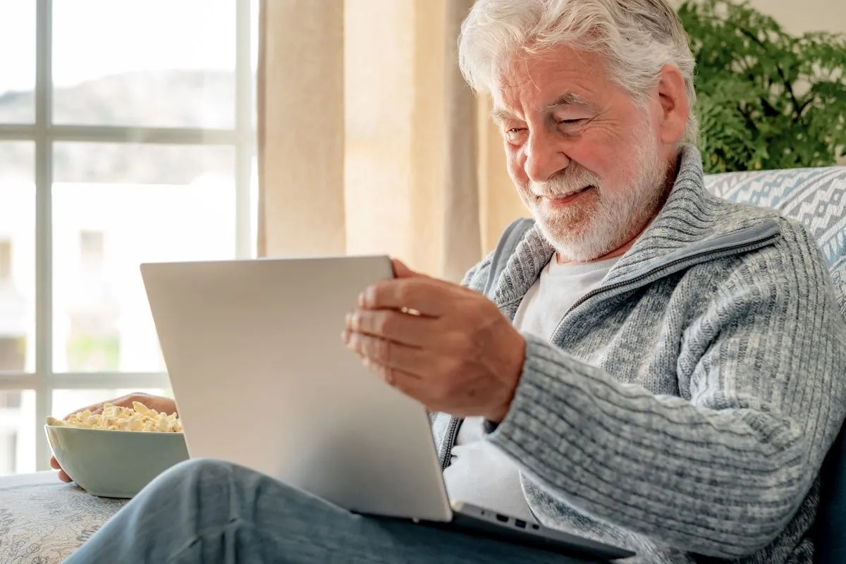 Senior man reading on his laptop