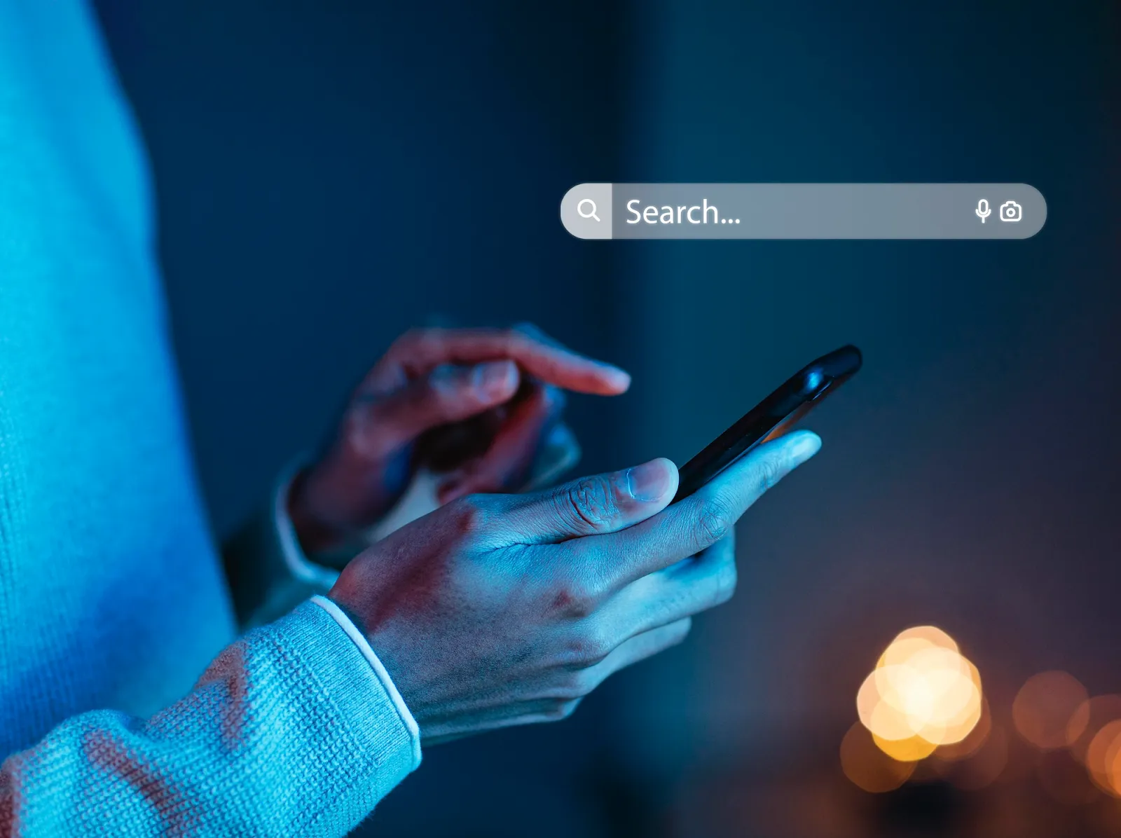 A search bar and a person holding a phone 