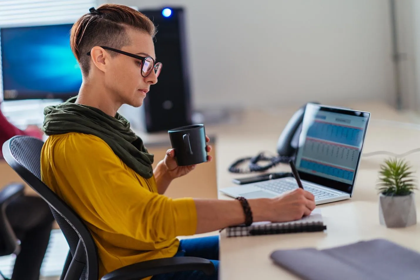 Office worker with coffee mug at desk