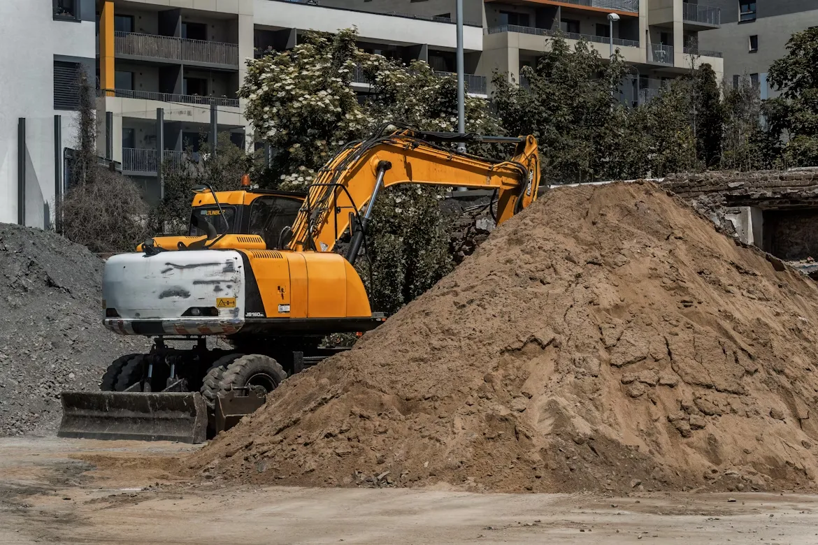 A large pile of dirt next to a building