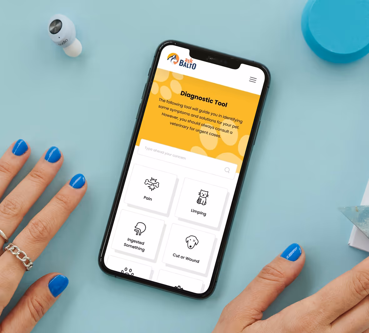 Mobile phone with the AskBalto platform on the screen on a blue background
