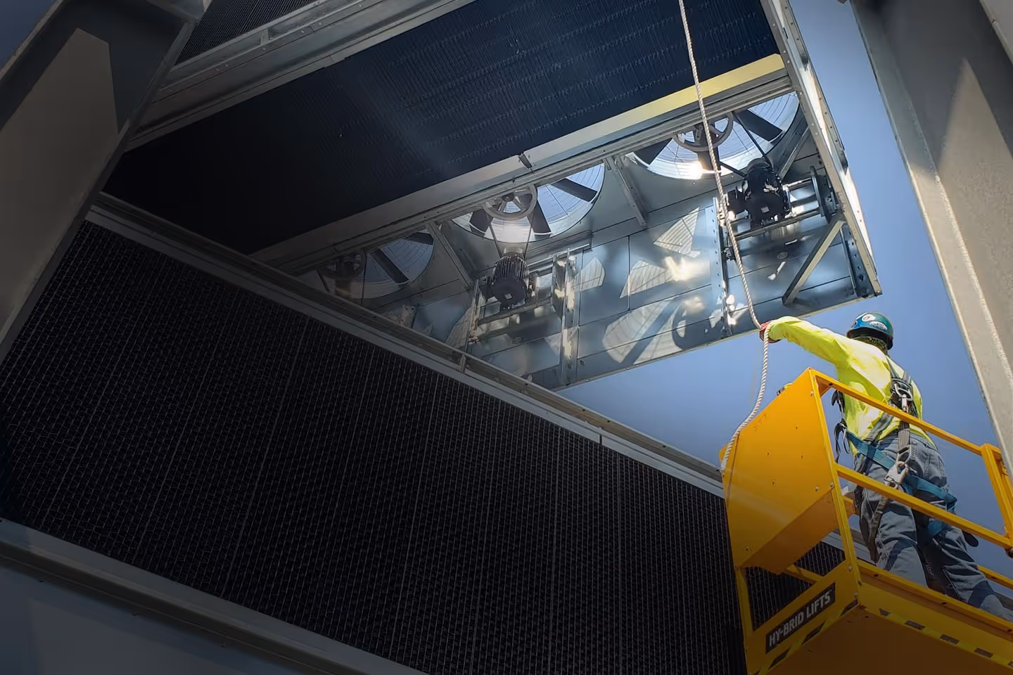 A man with a hardhat in a cherry picker