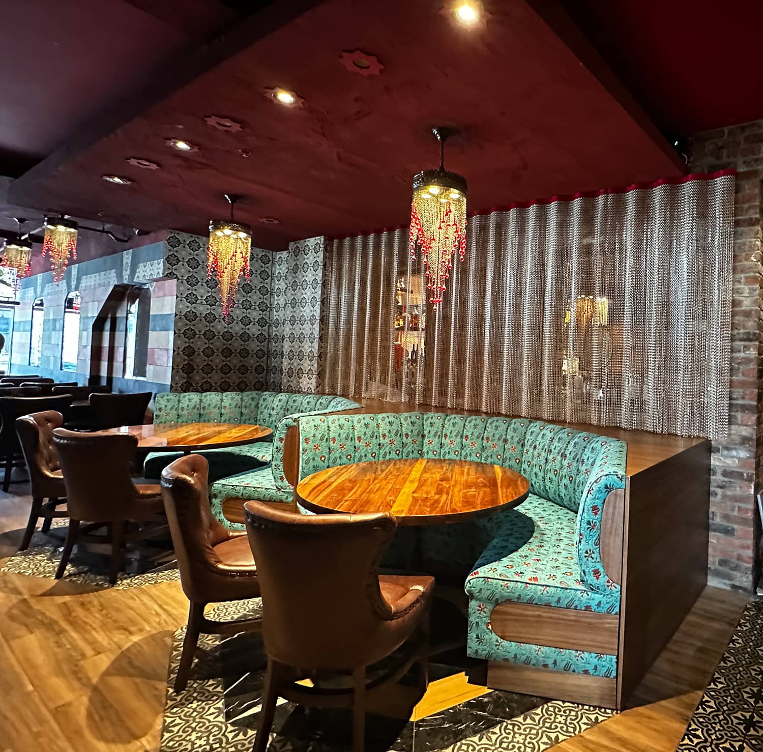 Elegant dining area in Damas restaurant featuring custom lighting, designed by Atelier MIM