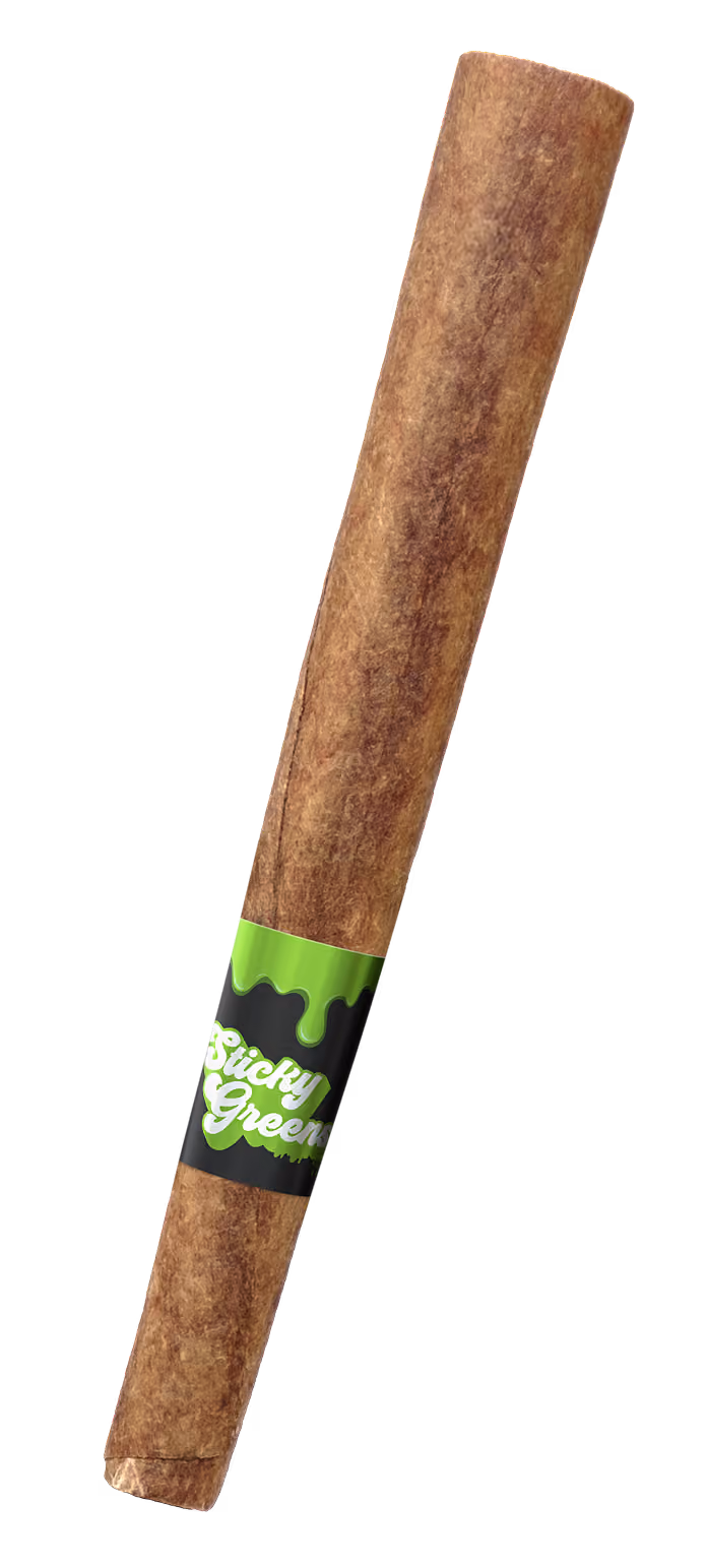 Close-up of a vape cartridge with yellow liquid labeled Sticky Greens and green drip design.