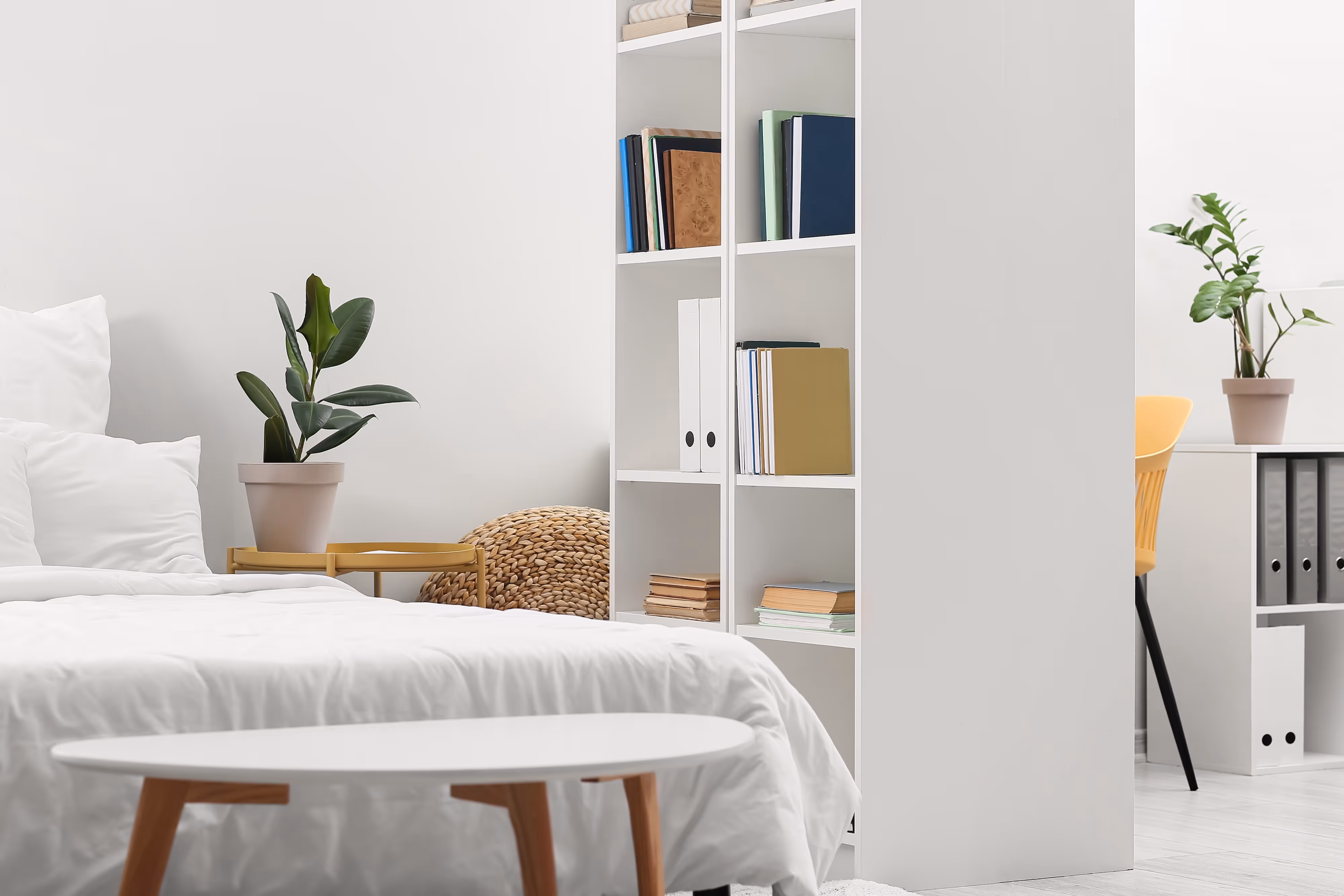Modern studio apartment at Crossing at 9th with minimalist decor, cozy bed, and built-in desk for student living in Salt Lake City