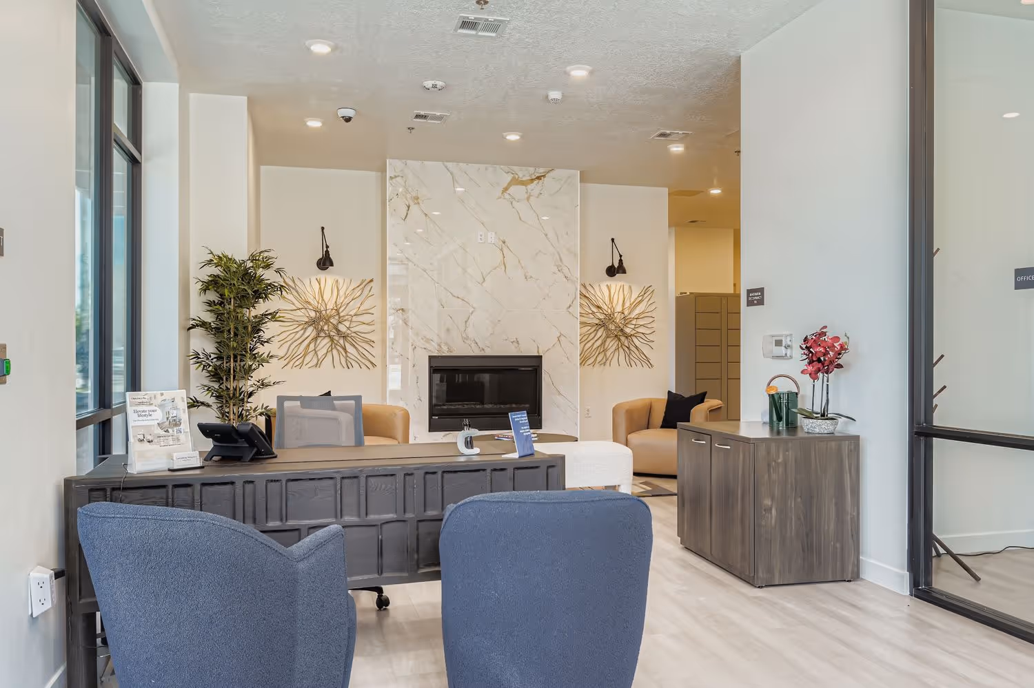 Lobby of Crossing at 9th apartment complex in Salt Lake City, Utah, showing seating area and desks.