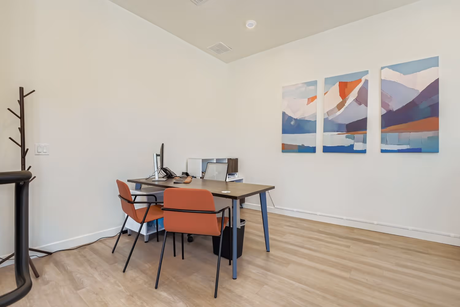 Office of Crossing at 9th apartment complex in Salt Lake City, Utah, showing desks with computers.