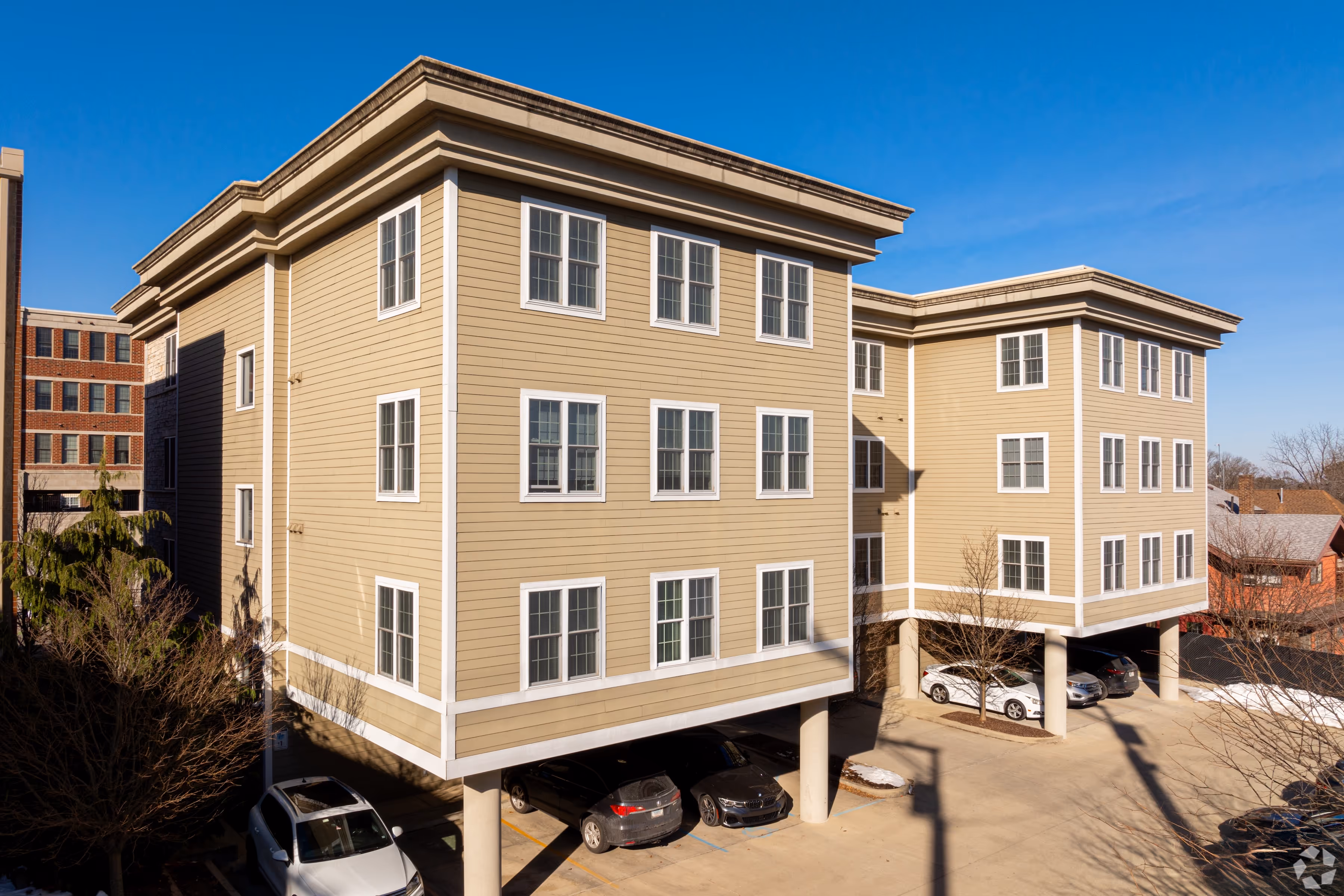 Exterior of 7 Ten apartment building featuring modern siding, multi-level windows, and covered ground-level parking.