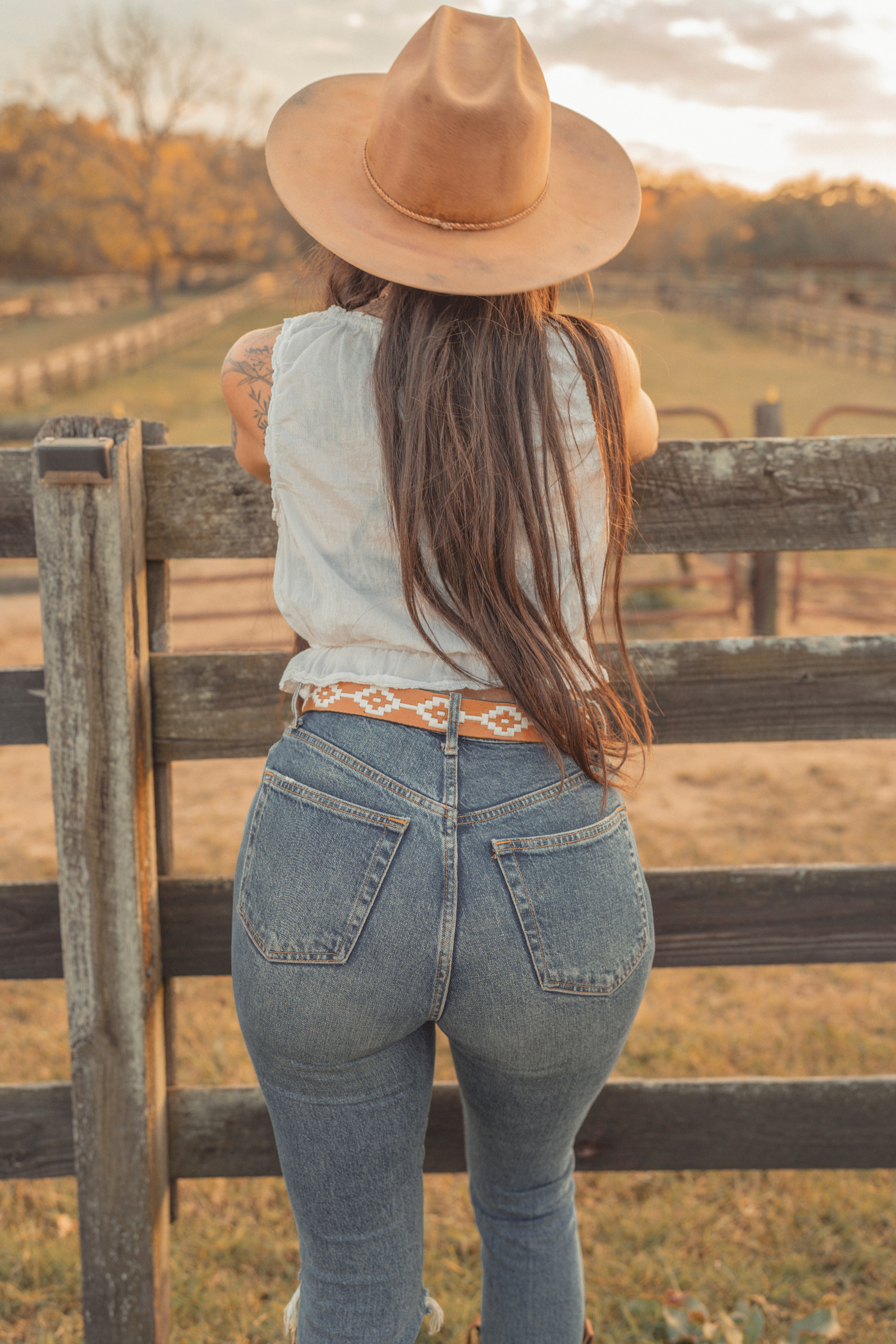A cowgirl model a Rambler belt from Zilker Belts