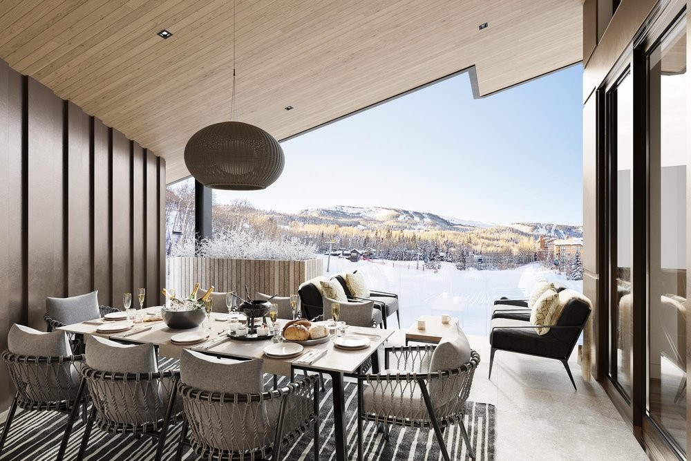 A terrace overlooking the Colorado Rocky Mountain landscape from a mass timber ceiling with a nice patio set underneath it.