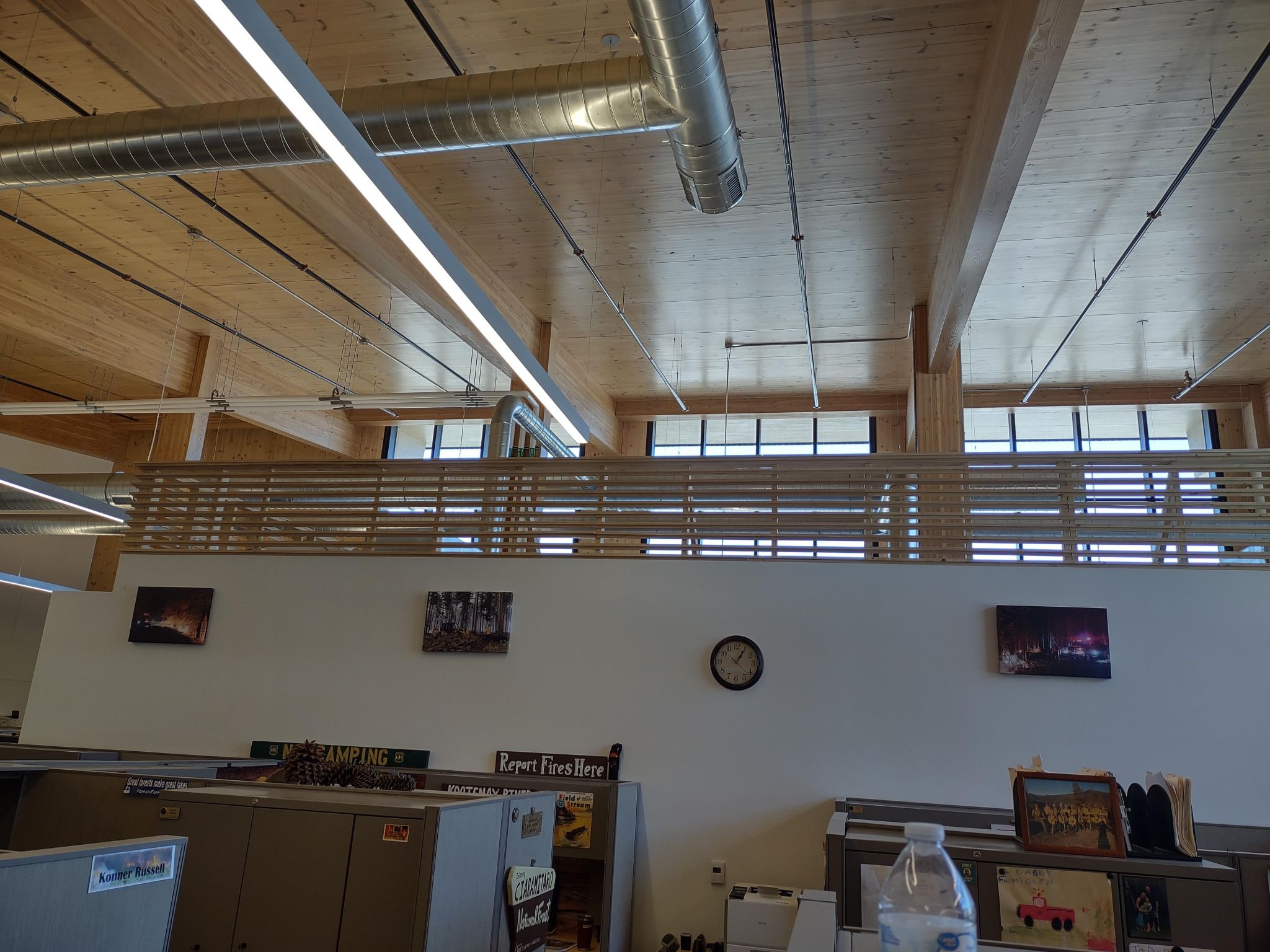 After the Michigan Department of Natural Resources State Building opened and staff had pictures hanging on the wall. Mass Timber Roof is exposed.