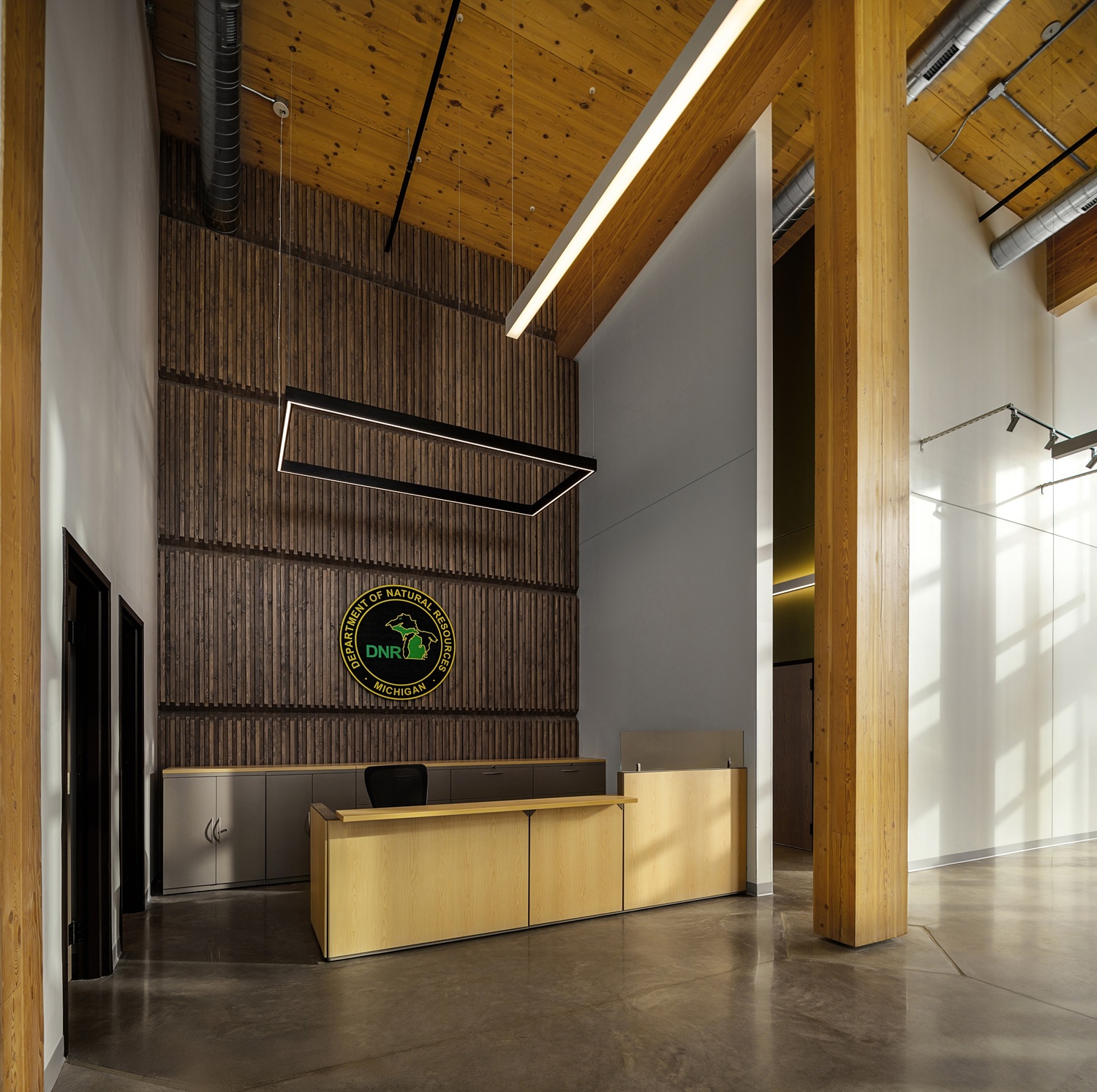 The Michigan Department of Natural Resources reception desk area with exposed mass timber beams and columns and ceilings.
