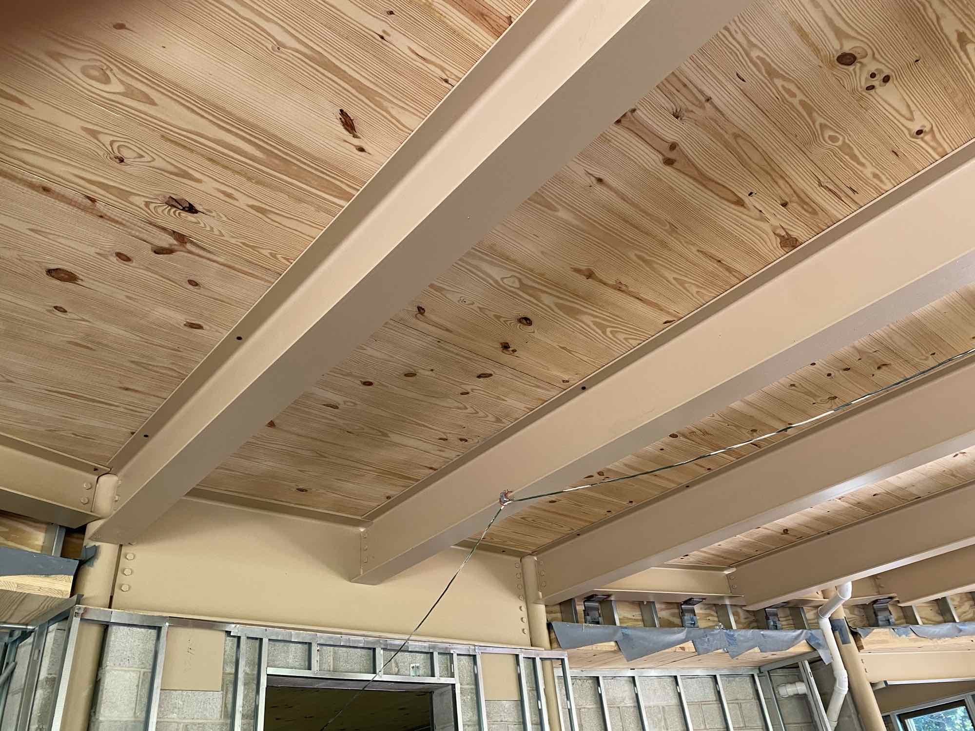 Construction from the inside of the mass timber ceiling of the Gateway Foundation Multipurpose Room Expansion from underneath.
