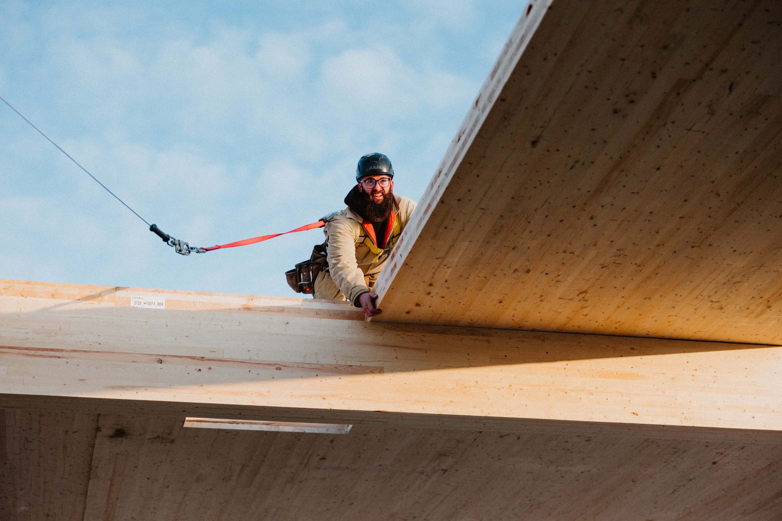 Installing Mass Timber with a harness on. 