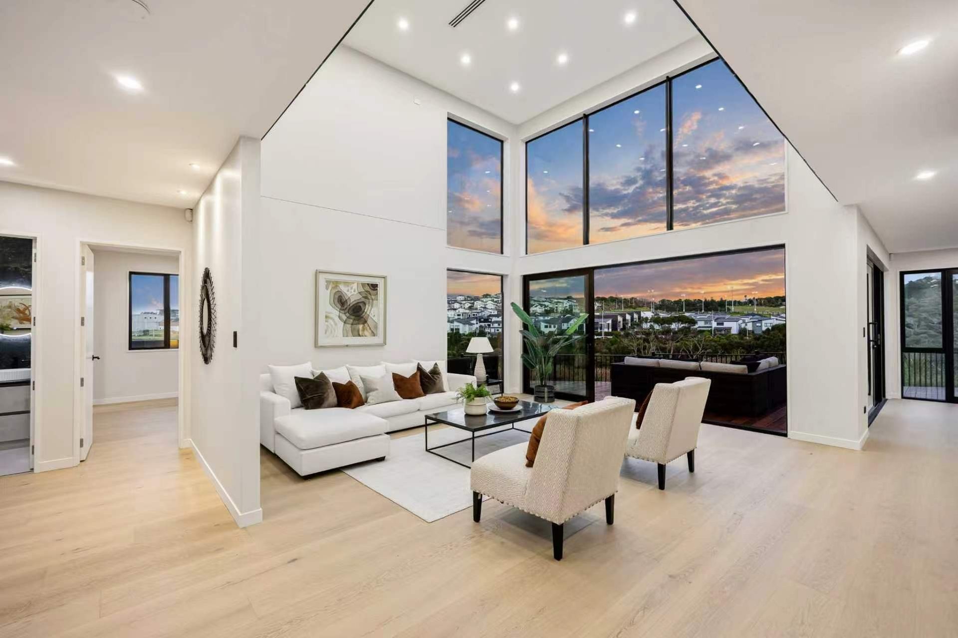 European oak engineered timber flooring in a double height living room at dusk, laid by Floorical in Tauranga