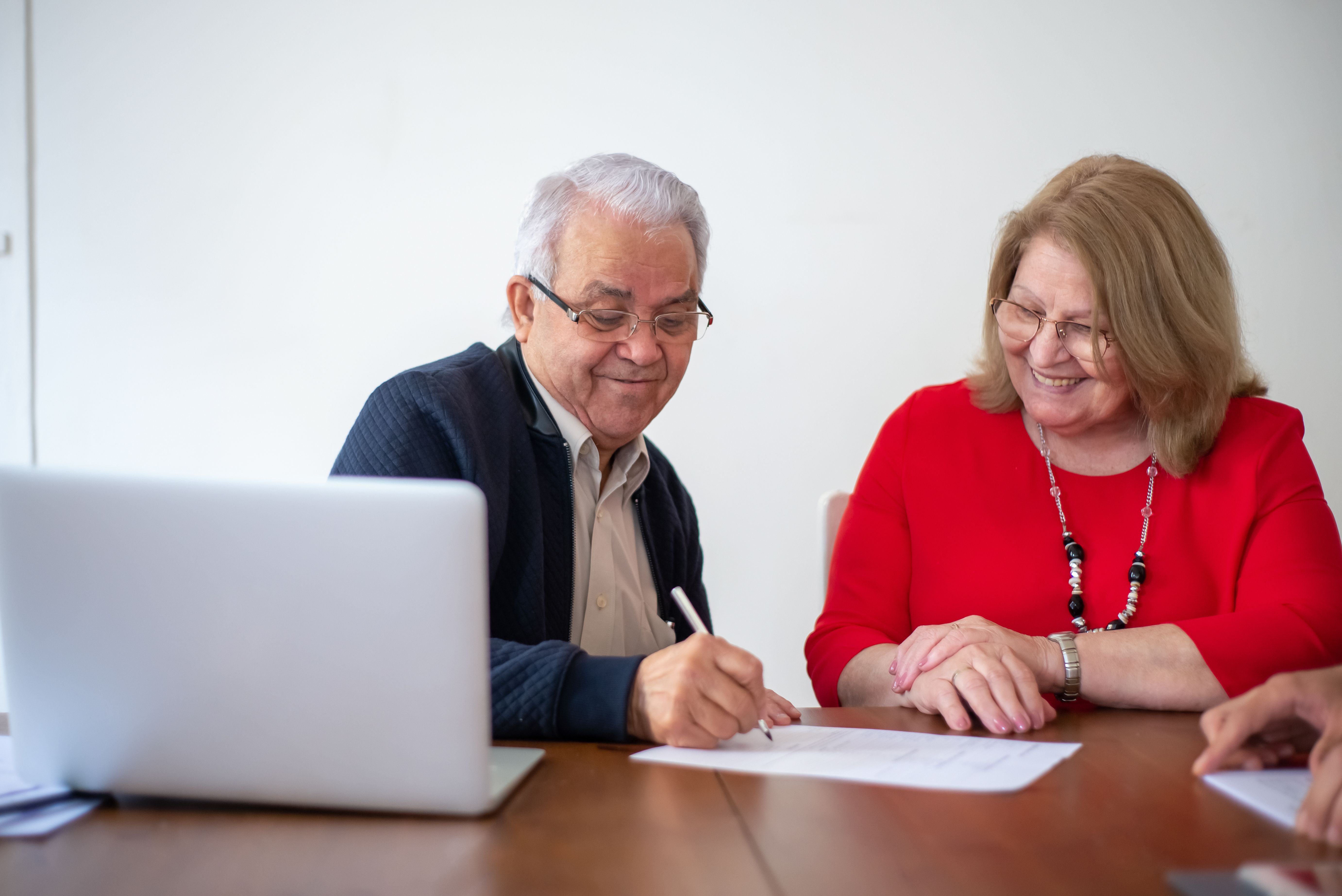 Couple reviewing and signing documents together