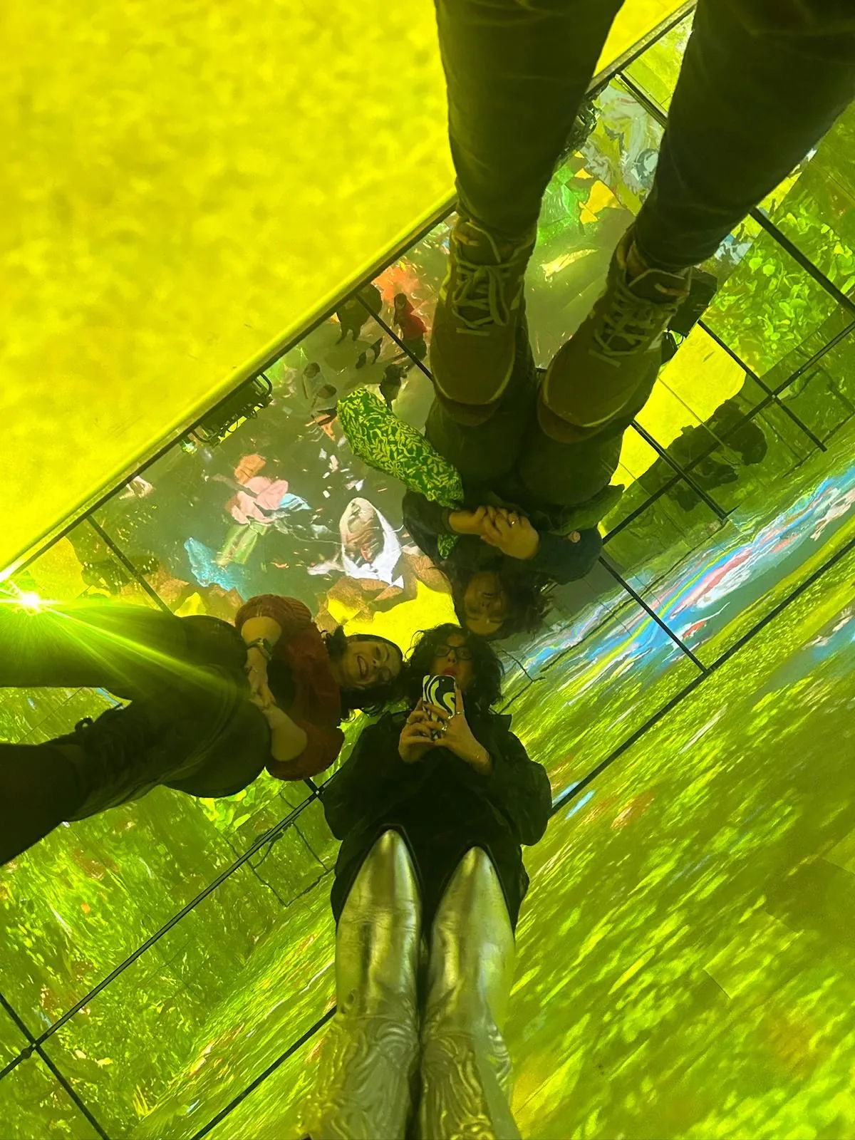 Team members exploring an immersive mirrored installation
