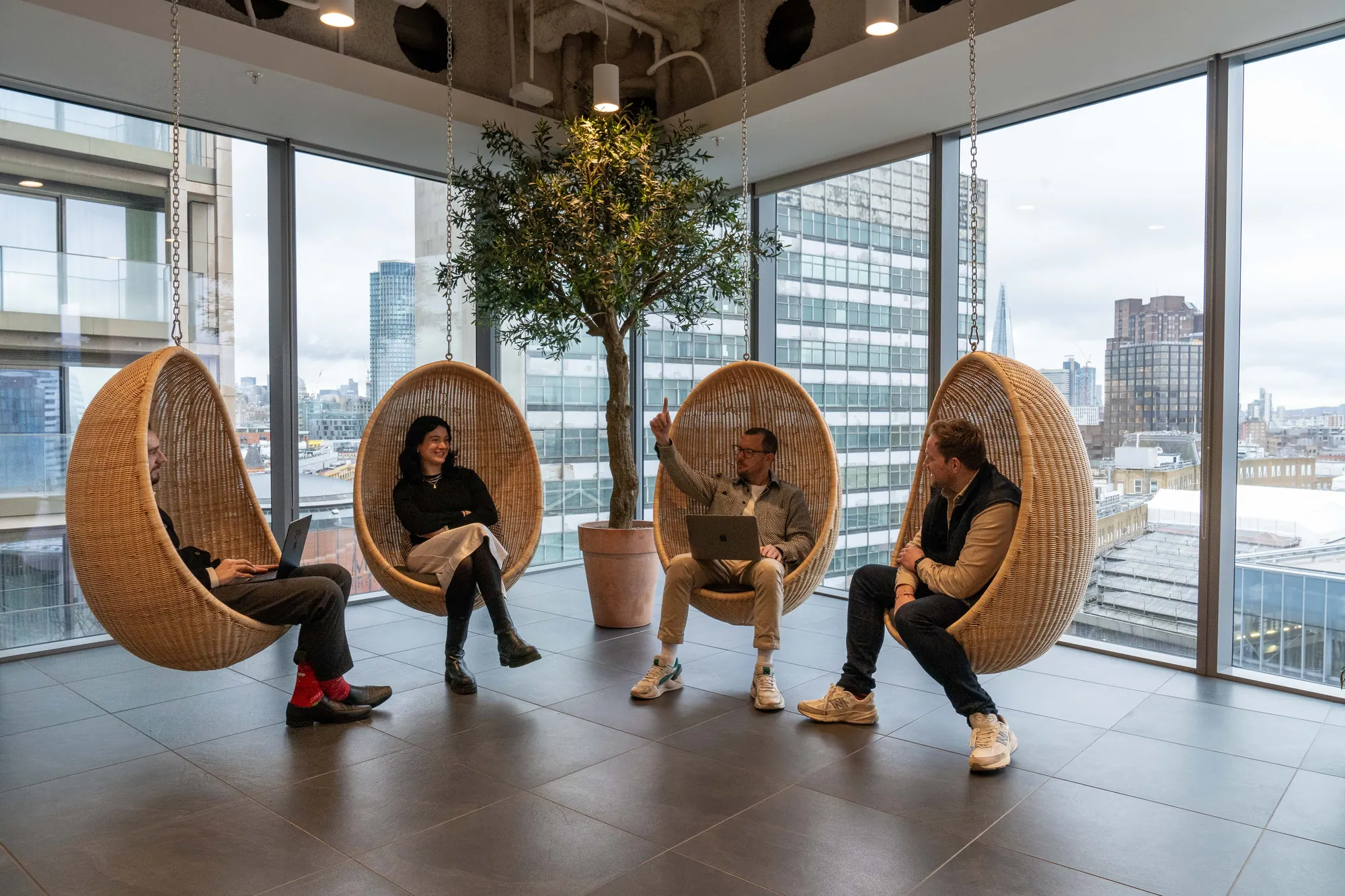 The INCEPTION team in the hanging chairs at WeWork 10 York Road