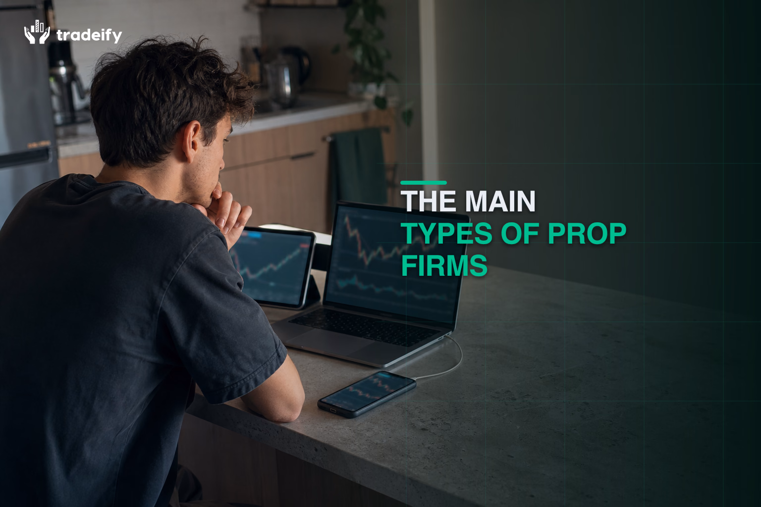 Trader comparing prop firm categories across a laptop tablet and phone at a kitchen island