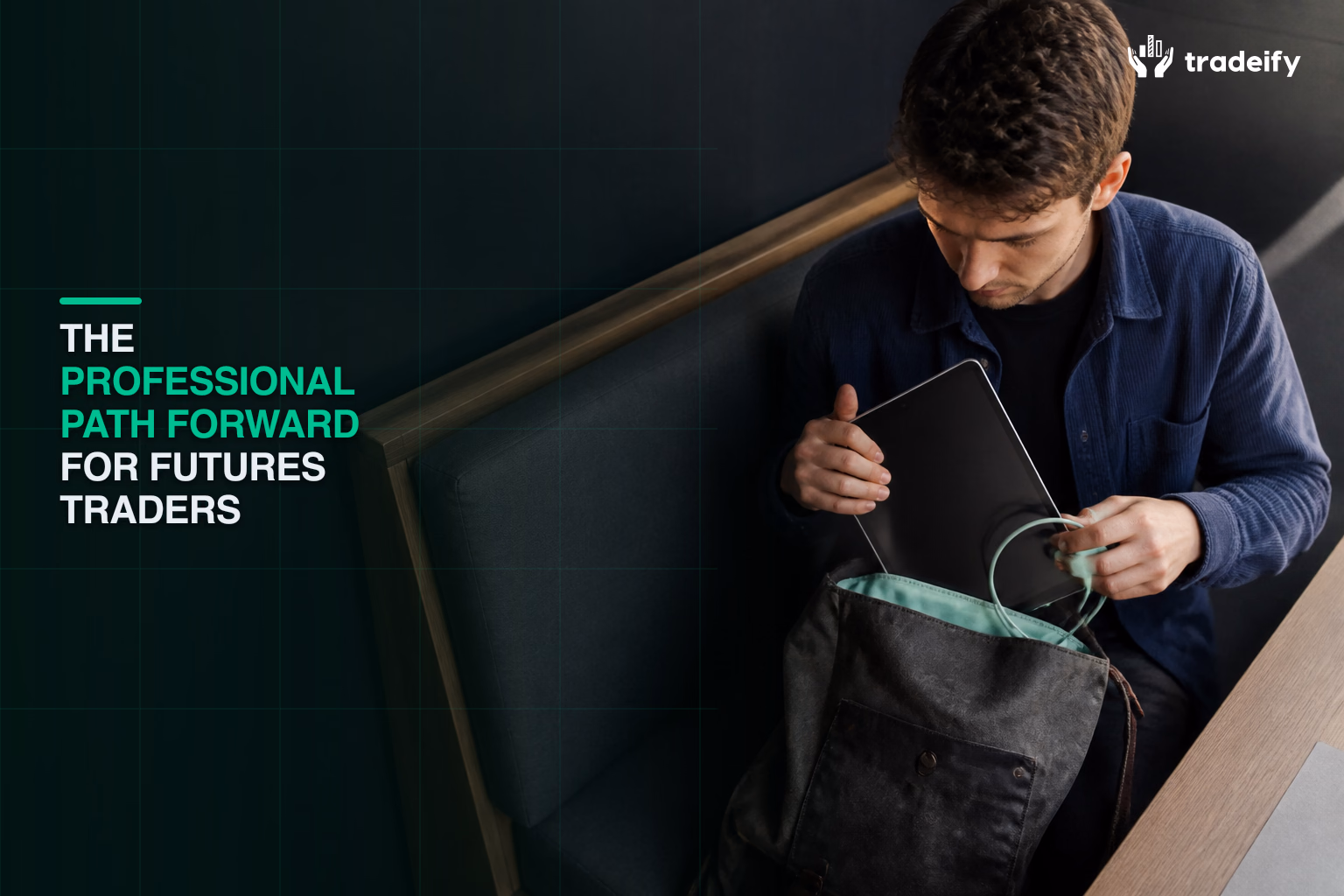 Young futures trader packing a tablet and charging cable into a backpack for a focused professional routine